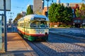 1072 trolley with green and red stripe on white streetcar on sunny road in San Francisco city, CA