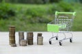 Trolley for groceries and goods from the supermarket and a lot of coins. Business concept, trade, poverty