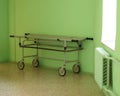 Trolley with a medical stretcher in the corridor of the clinic by the window