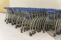 Trolley parking in a hypermarket, Light blue shopping carts, Many empty shopping carts in a row Royalty Free Stock Photo