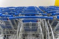 Trolley parking in a hypermarket, Light blue shopping carts, Many empty shopping carts in a row Royalty Free Stock Photo