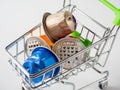 Trolley with used aluminum coffee capsules isolated on a white background. A concept for processing raw materials and recycling