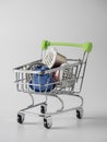 Trolley with used aluminum coffee capsules isolated on a white background. Vertical photo, a concept for processing raw materials