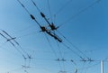 Trolleybus wires against the blue sky. Royalty Free Stock Photo