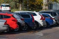 Long row of multi colored cars at a parking lot.. Royalty Free Stock Photo