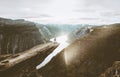 Trolltunga cliff and man traveler standing on edge in Norway Royalty Free Stock Photo