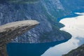 Trolltunga - famous rock formation and tourist famous hike, beautiful norwegian summer landscape with fjord, mountain and lake Royalty Free Stock Photo