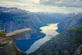 Trolltunga - famous rock formation and tourist famous hike, beautiful norwegian summer landscape with fjord, mountain and lake Royalty Free Stock Photo