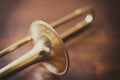 Trombone on wooden floor detail Royalty Free Stock Photo