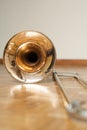 Trombone on wooden floor detail Royalty Free Stock Photo