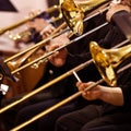 Trombones in the hands of musicians Royalty Free Stock Photo