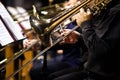 Trombones in the hands of musicians in the orchestra