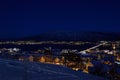 Tromso city at winter snowy night with light,traffic,fjord and motion with mainland