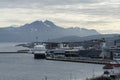 Tromso port with a big ship anchored and smow mountains