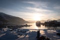 TromsÃÂ¸ Port with Cruise Yacht and Sunset Behind Mountains in Winter