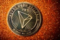 TRON coin on dark background close up