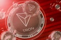 TRON TRX crash, bubble. TRON TRX cryptocurrency coins in a bubbles on the binary code background