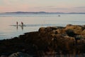 With Trondheim fjord sup board three people on water rocks sunset