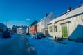 TRONDHEIM, NORWAY - APRIL 04, 2018: Outdoor view of traditional Scandinavian wooden living houses stand along old street