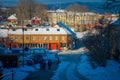 TRONDHEIM, NORWAY - APRIL 04, 2018: Unidentified people walking in traditional Scandinavian wooden living houses stand