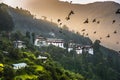 Dawn of Trongsa Dzong , birds wheeling in the air above the castle , Bhutan Royalty Free Stock Photo