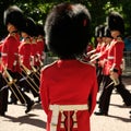 Trooping the Colour ceremony, London UK. Soldiers marching in background as one soldier in foregound stands to attention. Royalty Free Stock Photo