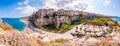 Tropea cityscape panorama with high cliffs with built on top city buildings and apartments, Rotonda beach full of people, streets