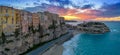 view of Rotonda Beach and the colourful old town of Tropea in Calabria at sunset