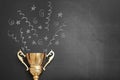 Trophy and chalk drawn confetti salute on black background, space for text Royalty Free Stock Photo