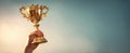 The trophy held high symbolizing victory and achievement against a beautiful backdrop..AI generated image Royalty Free Stock Photo