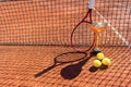 Trophy, professional tennis racket and balls on a red clay tennis court and net shadow. Winning concept. Copy space Royalty Free Stock Photo