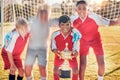 Trophy, soccer and team in celebration of success as winners of a sports award in a childrens youth tournament. Happy Royalty Free Stock Photo