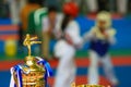 Trophy for Taekwondo contest with athletes fighting in background Royalty Free Stock Photo