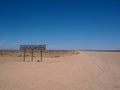 Tropic of capricorn line signage along the desert road with blue