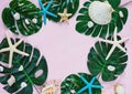 Tropic monstera leaves, starfish, shells on pink background. Summer fashion flat lay, vacation, travel concept. Top view