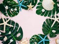 Tropic monstera leaves, starfish, shells on pink background. Summer fashion flat lay, vacation, travel concept. Top view