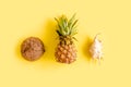 Tropical abstract background, pattern with coconut and pineapple, on yellow background. Summer concept. Flat lay, top Royalty Free Stock Photo