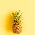 Tropical abstract background, pattern with coconut and pineapple, on yellow background. Summer concept. Flat lay, top Royalty Free Stock Photo