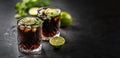 Tropical alcoholic cocktail Cuba Libre composed of white rum, cola, ice cubes, lime and mint Royalty Free Stock Photo