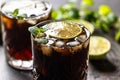 Tropical alcoholic cocktail Cuba Libre composed of white rum, cola, ice cubes, lime and mint Royalty Free Stock Photo