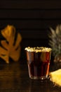 Tropical alcoholic shot garnished with chips