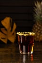 Tropical alcoholic shot garnished with chips