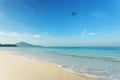 Tropical andaman seascape scenic off mai khao beach and wave crashing on sandy shore in phuket thailand with airplane takes off o