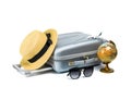 Tropical background. Suitcase, sunglasses with toy plane, straw hat and globe in travel composition isolated on white background. Royalty Free Stock Photo