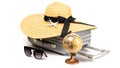 Tropical background. Suitcase, sunglasses with toy plane, straw hat and globe in travel composition isolated on white background. Royalty Free Stock Photo