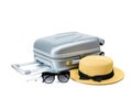 Tropical background. Suitcase, sunglasses with toy plane and straw hat in travel composition isolated on white Royalty Free Stock Photo