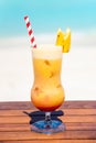 Tropical banana cocktail with straw on the wooden table at the beach with ocean Royalty Free Stock Photo