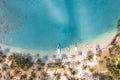 Tropical beach aerial photography with coconut palm trees along the coast and blue transparent sea water with coral reef, paradise Royalty Free Stock Photo