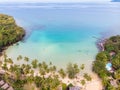 Tropical beach aerial view from drone with blue transparent sea water and coconut palm trees, seaside tourist hotel resort with Royalty Free Stock Photo