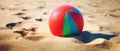 Tropical beach ball on sand, ocean summer holiday background colorful beach ball in sand